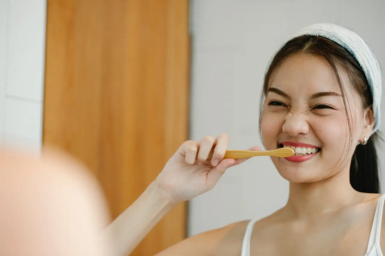 lady brushing after Dental Crowns