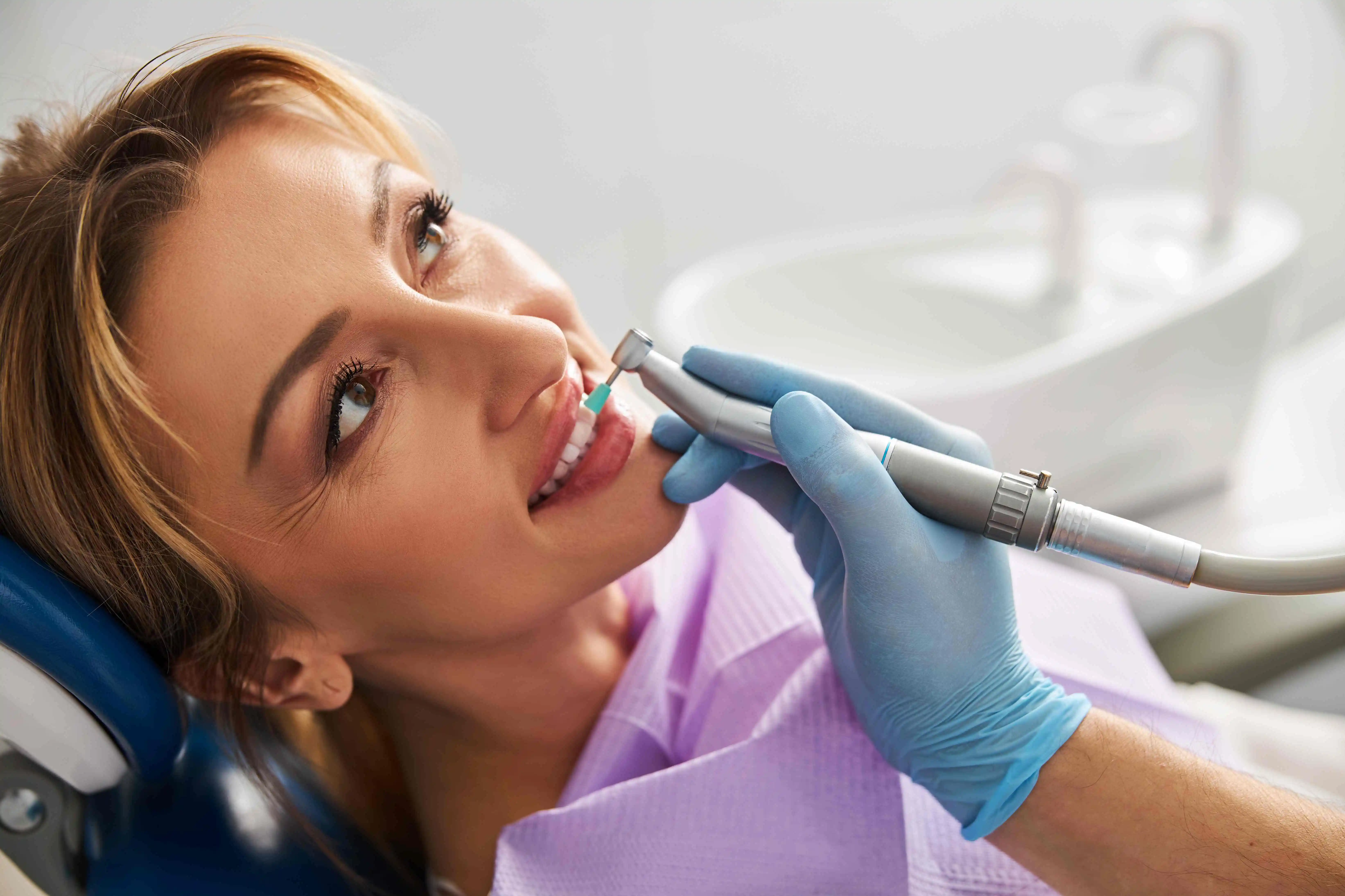 Smiling girl teeth cleaning in dentist office