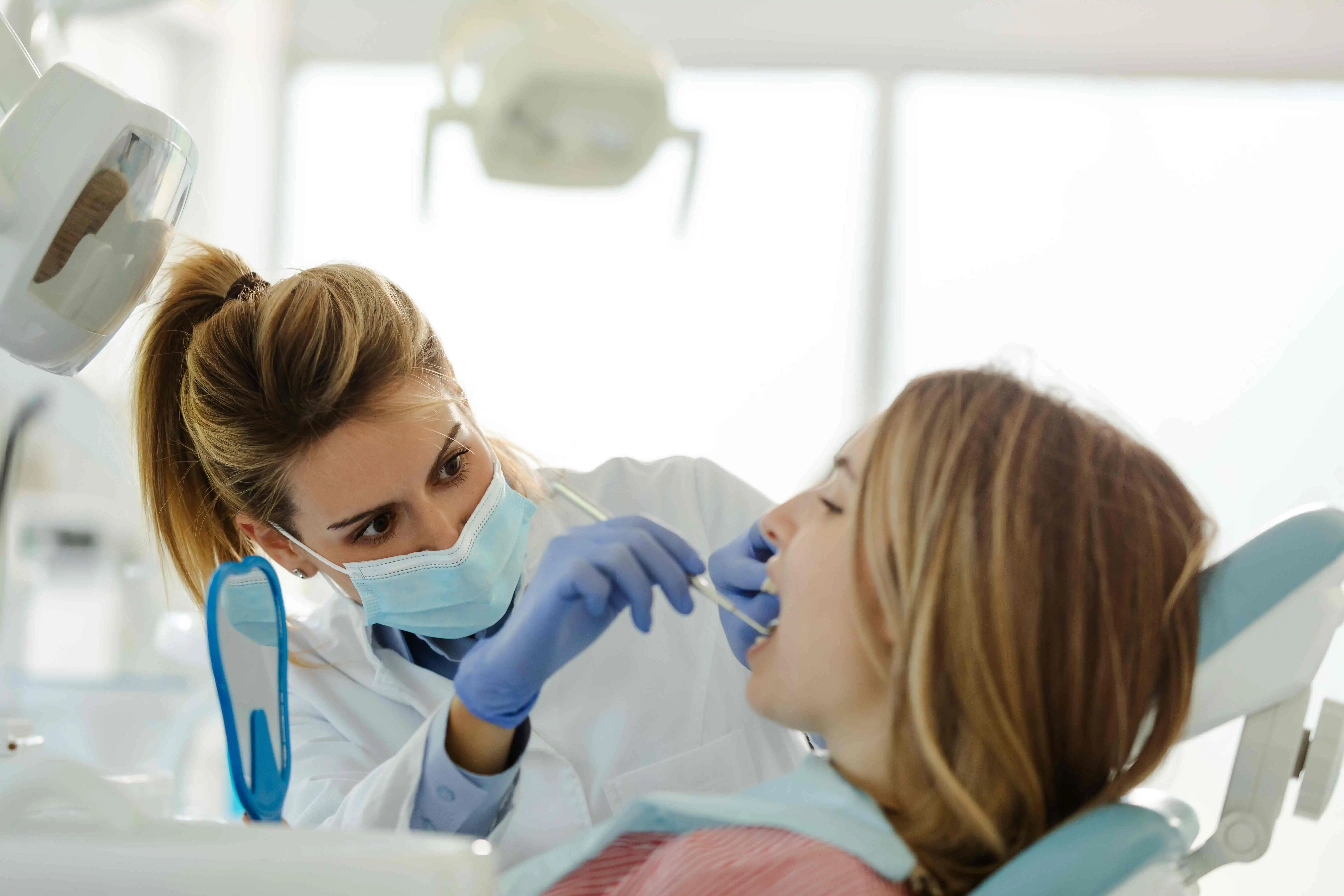 dentist with patient in dental clinic 